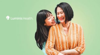 Asian mom and daughter hugging with Luminis Health logo