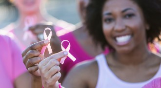 women holding breast cancer awareness ribbons