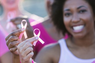 women holding breast cancer awareness ribbons