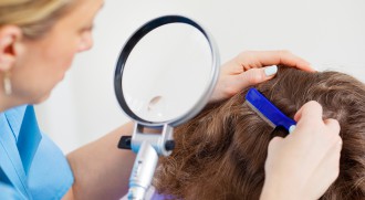 Inspecting a child's head for lice