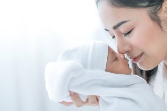 Asian mom with newborn baby