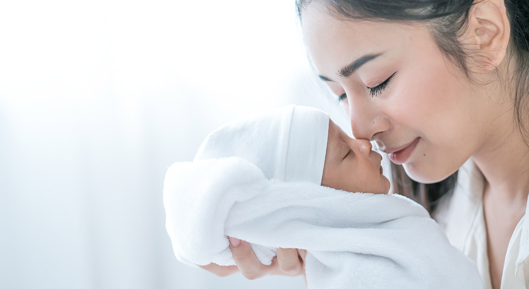 Asian mom with newborn baby