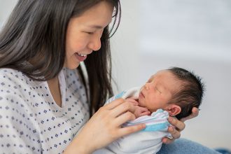 Woman holding a newborn baby