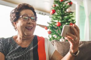senior woman talking on a smartphone at Christmas